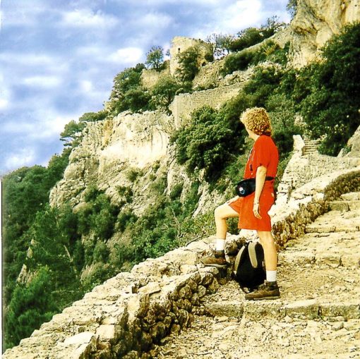 Image if a walker resting on rock steps on Mallorca, Spain